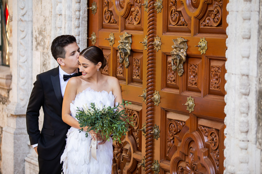 couple by carved mexican door casa faller elizabeth medina yucatan wedding blog 0066 Casa Faller and Mansion Merida, Wedding Day Photos in Merida’s Most Elegant Wedding Venues, Maribel and Robertocouple by carved mexican door casa faller  