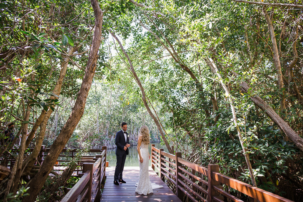 elegant bride and groom depicted surrounded by lush jungle landscape